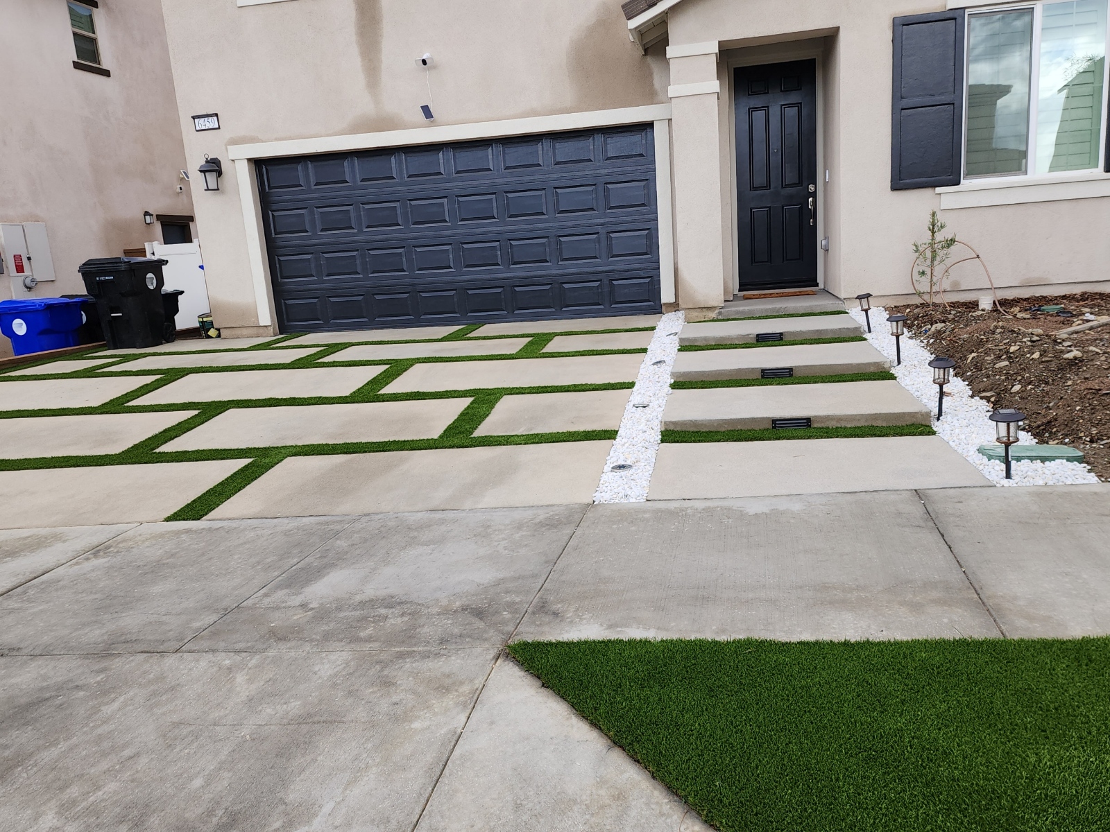 Modern driveway with turf bands